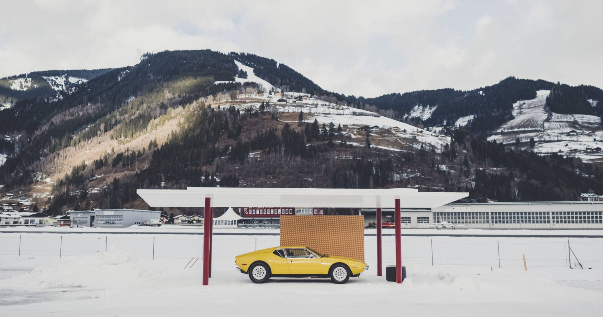 <span>Ein alter gelber De Tomaso Pantera wird in einem tragbaren Pavillon präsentiert, der von Ferdis Architekturbüro Steiner Architecture für das GP Ice Race 2022 entworfen wurde </span> <br/><span class="caption-sub"><em>Bildnachweis: Amy Shore </em></span><br/>